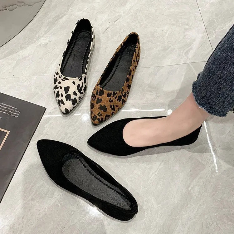 Women's leopard print flat pointed toe pumps with low heel on beige background