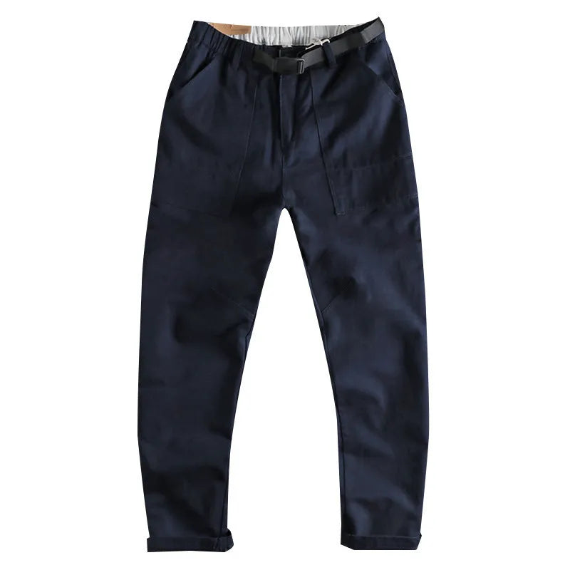 Men's dark blue cotton work trousers with N I buckle belt showing three-dimensional cutting and zip fly fastening