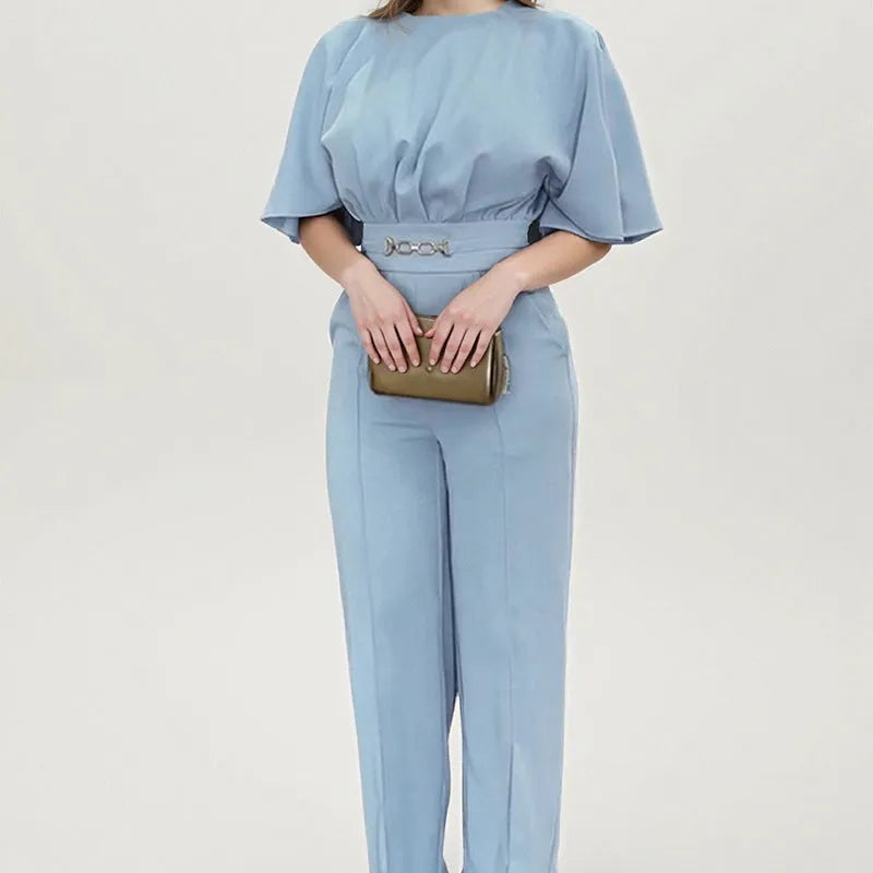 Blue men's slim fit two-piece polyester suit with long sleeve jacket and trousers on a hanger.