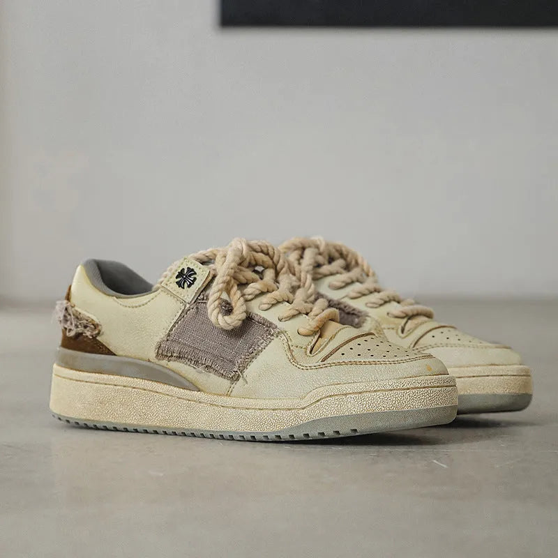 Beige low-top vintage style skate shoes with lace-up front and rubber sole.