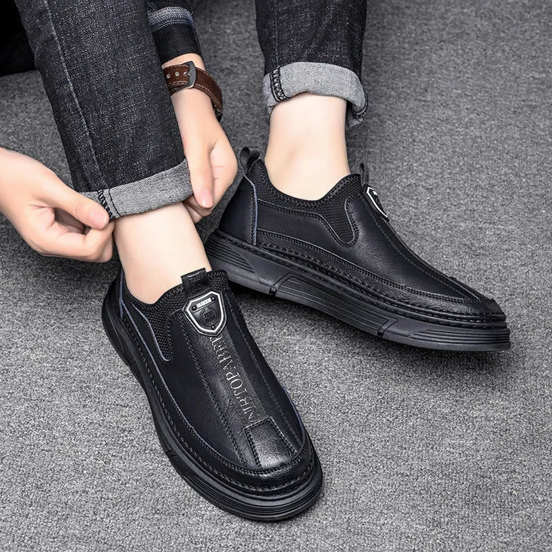 Men's black leather casual shoes with round toe design on solid colour background