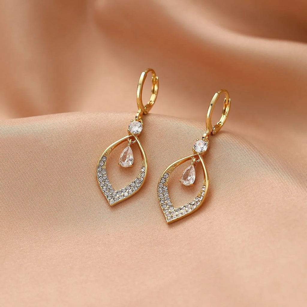 Gold and silver coloured women's teardrop zircon tassel earrings on a copper base.