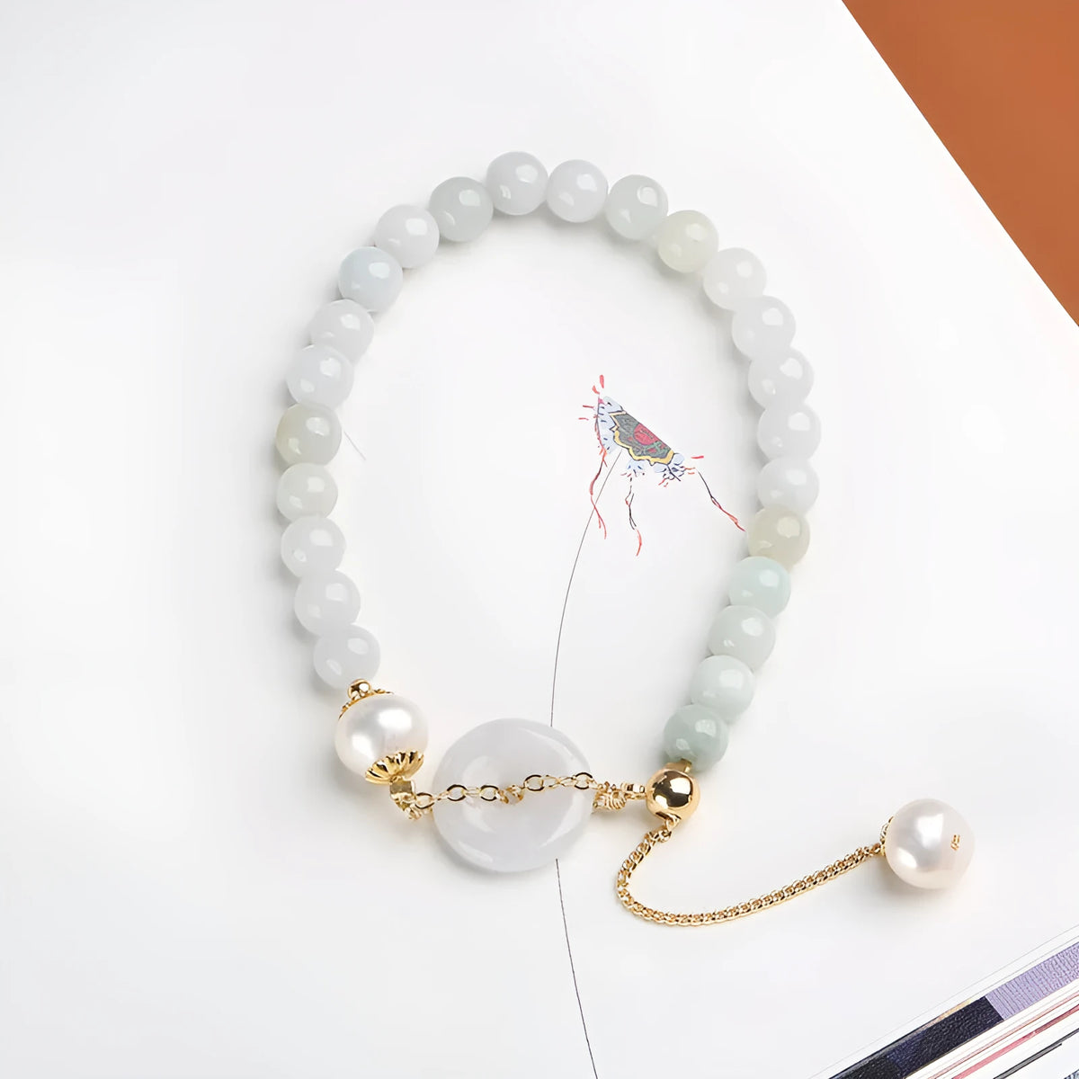 Women's natural emerald peace buckle pearl bracelet with geometric jade pendant on wrist