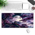 Large black gaming mouse pad with pattern design measuring 400x900mm on desk