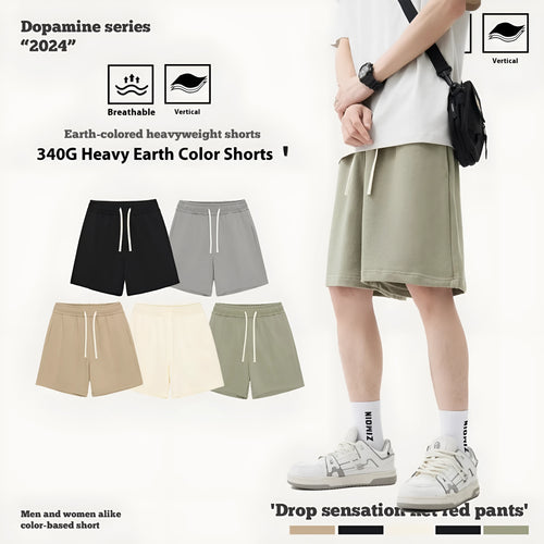 Baby boy and girl wearing loose-fit cotton denim shorts in charcoal grey and cream apricot colours.