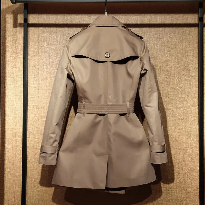 Khaki women's double-breasted trench coat with flight sleeves on a hanger.