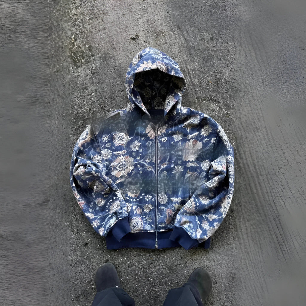 A man's loose-fitting blue hooded zip coat with long sleeves, shown front-on.