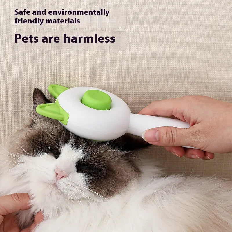 A greenish white and orange cat grooming comb with stainless steel teeth and a self-cleaning button.