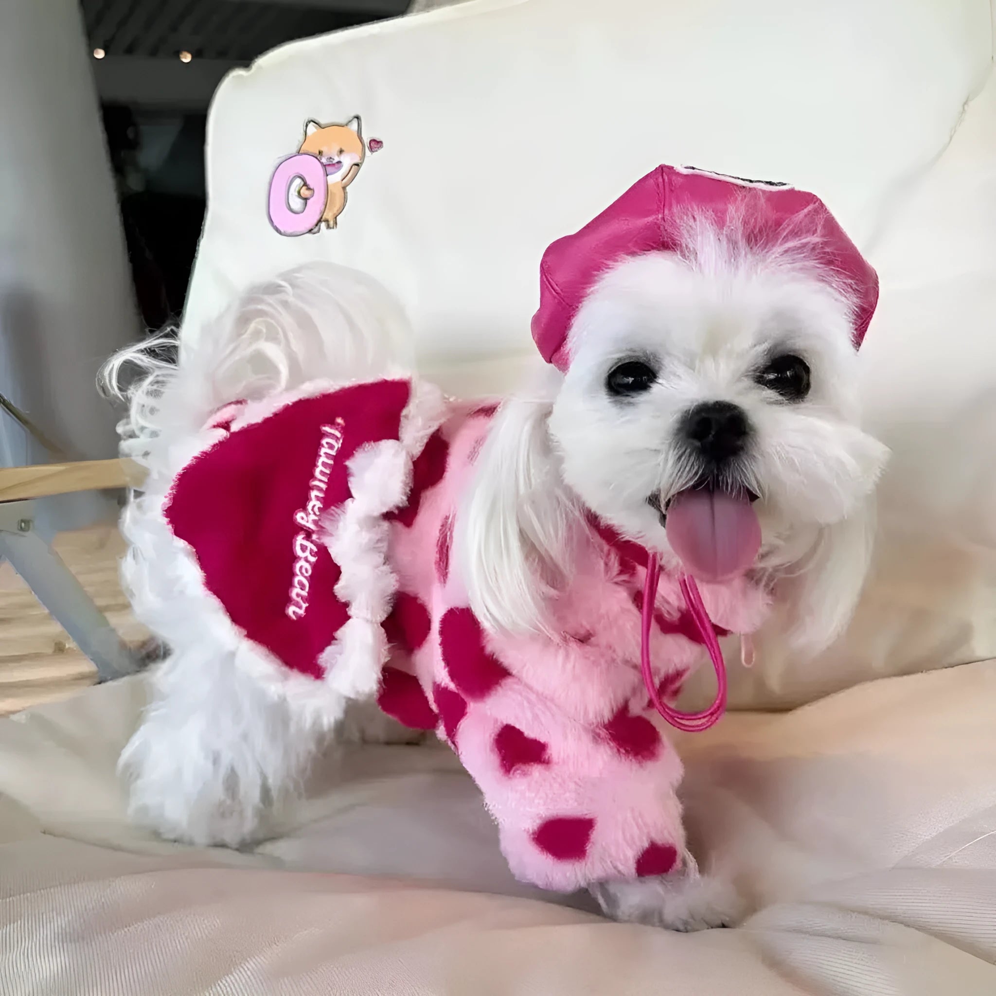 British style pink polyester warm coat on a small white dog, showing the fit and traditional design.