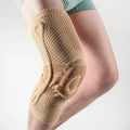 Adult black and blue sports knee pads made from nylon and spandex, shown on a knee.