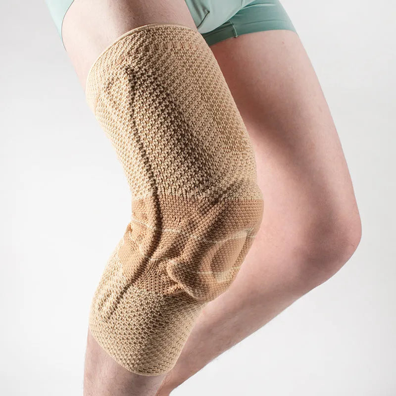 Adult black and blue sports knee pads made from nylon and spandex, shown on a knee.