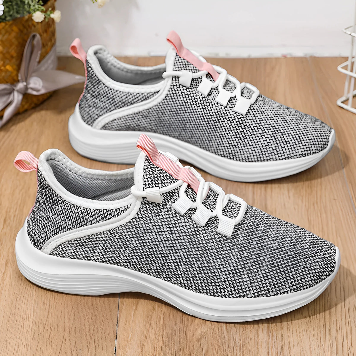 Women's low-top mesh sneakers in black, grey, or pink with breathable flyknit design and EVA sole