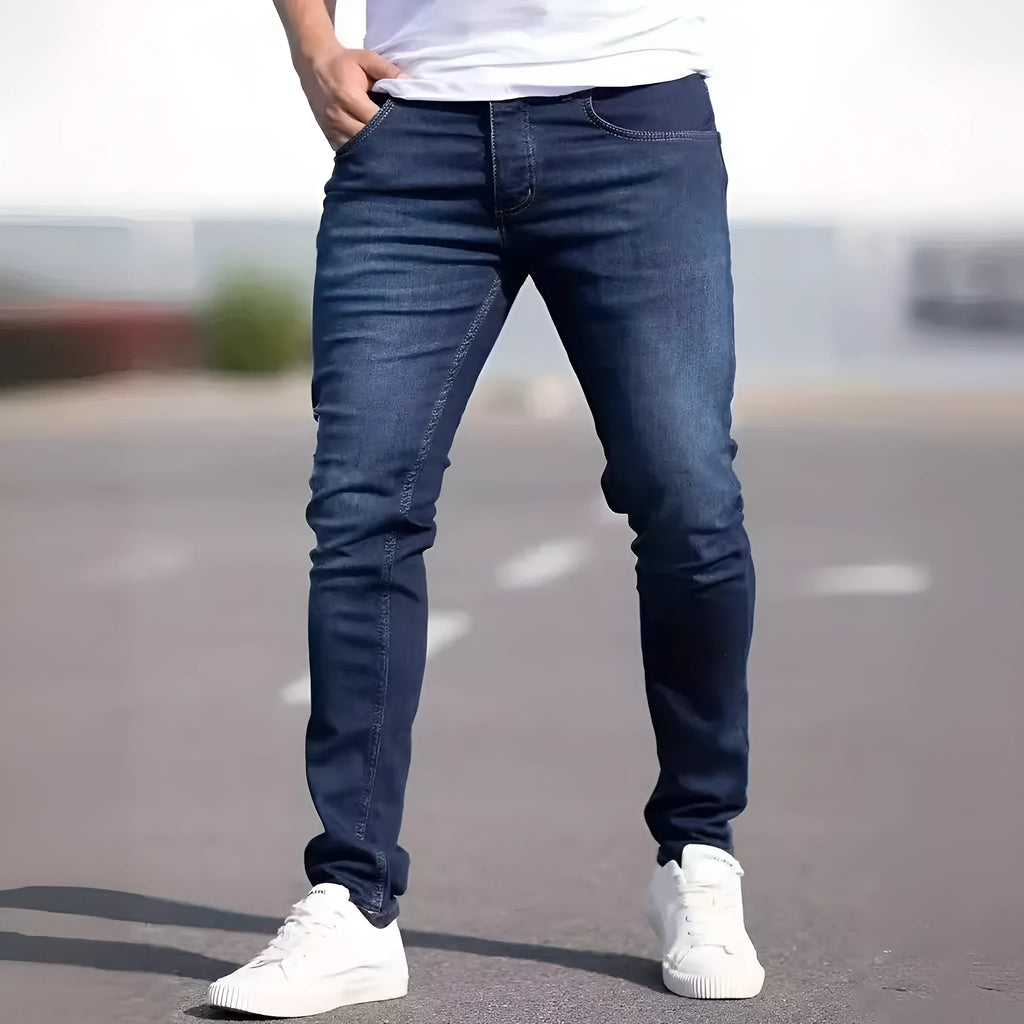 Men's dark blue cotton skinny jeans with elastic waistband shown on model