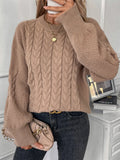 Women's beige loose-fitting sweater with twisted detailing on a hanger.