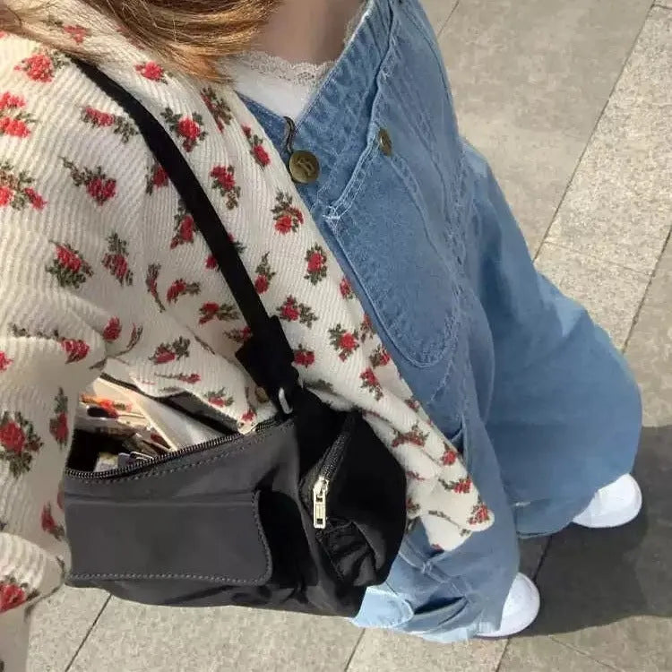 Black double pocket shoulder bag with side line detailing showing interior organisation