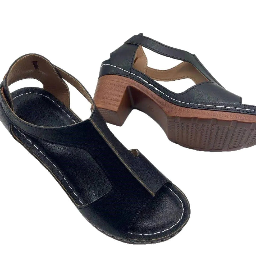 Women's peep toe wedge sandals with Roman-style buckle on a low heel.