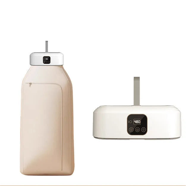 White cylindrical foldable clothes dryer with remote control on a table.