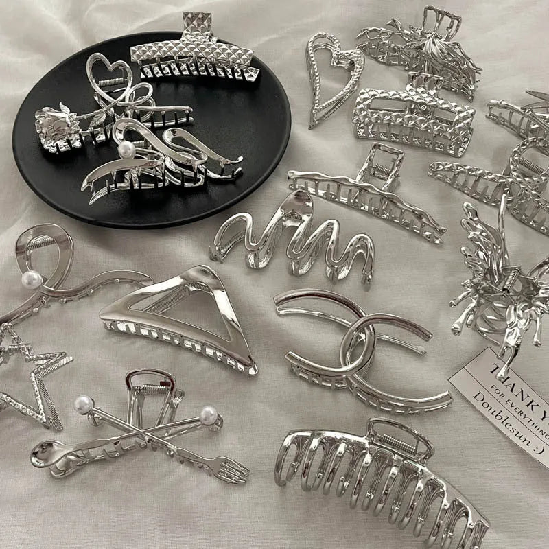 Silver metal hair clips collection with various Korean style designs including bows, pearls, and wave patterns