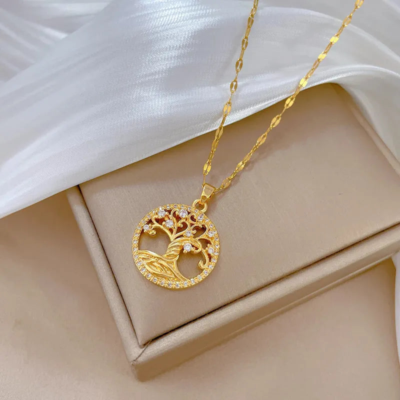 Gold plated stainless steel necklace with mother of pearl lucky tree pendant and cross elements on a lip chain