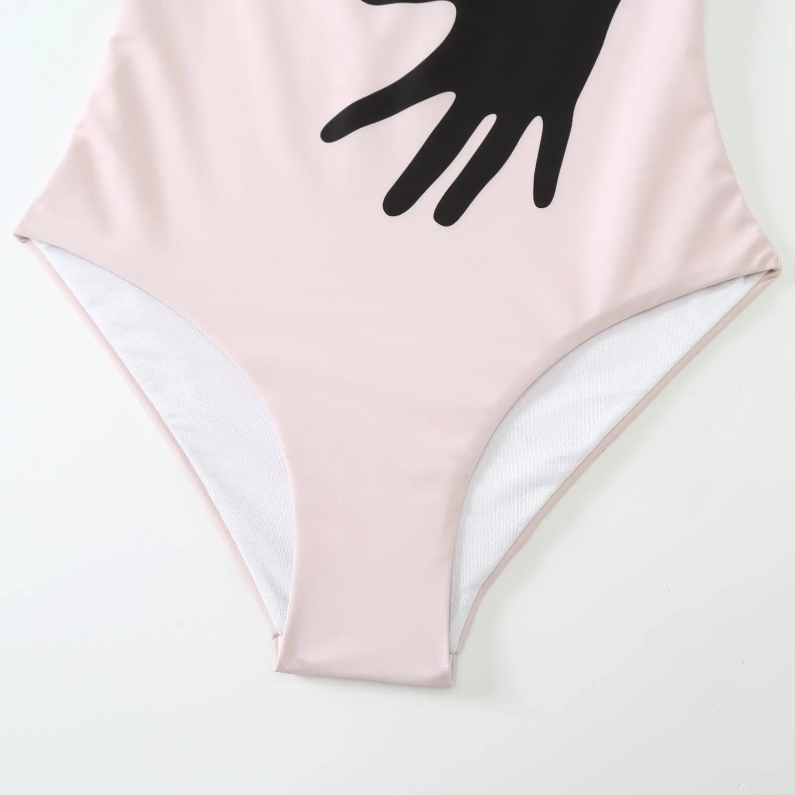 Women's patterned one-piece bikini swimsuit with a separate white tulle skirt laid flat.