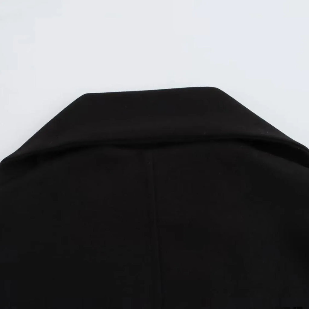 Women's long grey coat with artificial fur collar, shown with pockets and street-fashion styling.