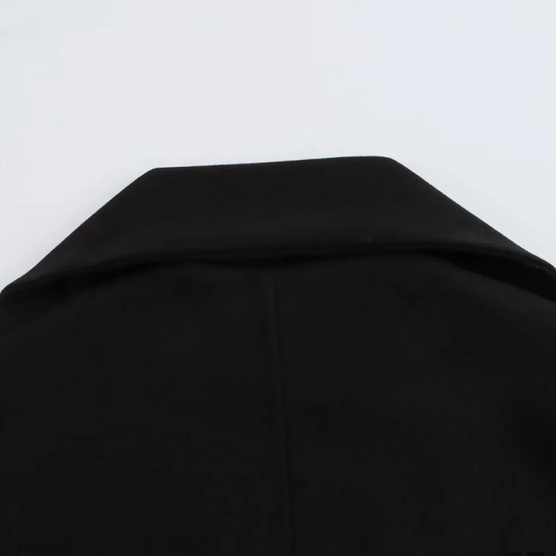 Women's long grey coat with artificial fur collar, shown with pockets and street-fashion styling.