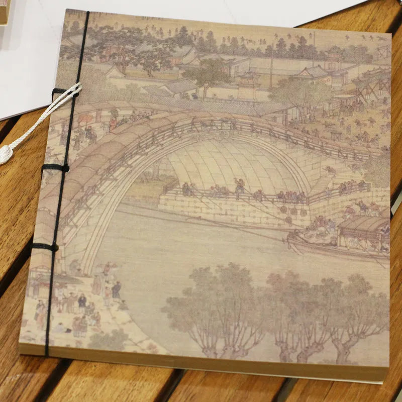 A5 antique wire-bound notebook with glossy embossed cover featuring a retro painting design, shown open.