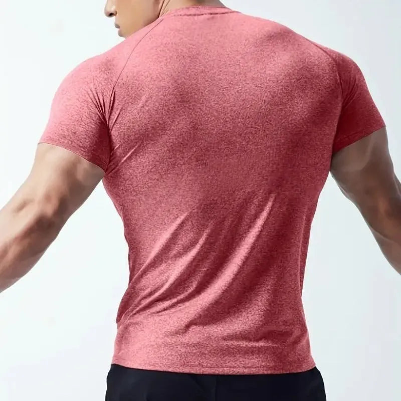 Man wearing a tight-fitting green casual short-sleeve t-shirt with a round neck.