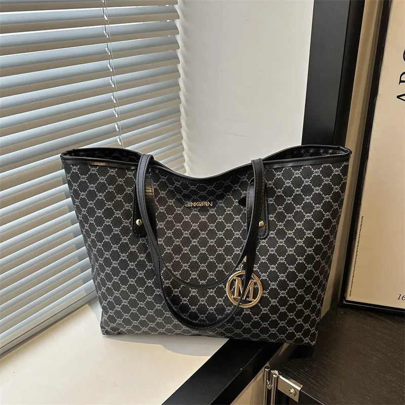 PU leather shoulder bag with sewing thread detail in black colour showing 42cm width and structured design