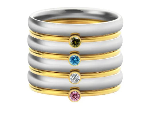 Women's titanium steel ring with engraved geometric December birthstone design on a finger.