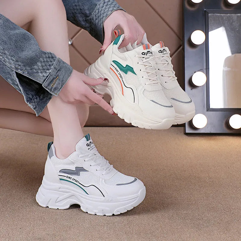 White women's dad shoes with cross shoulder straps and a round toe, shown on a foot.