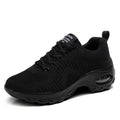 Women's black mesh sneakers with round toe, front lace-up closure, and mid heel on grey background