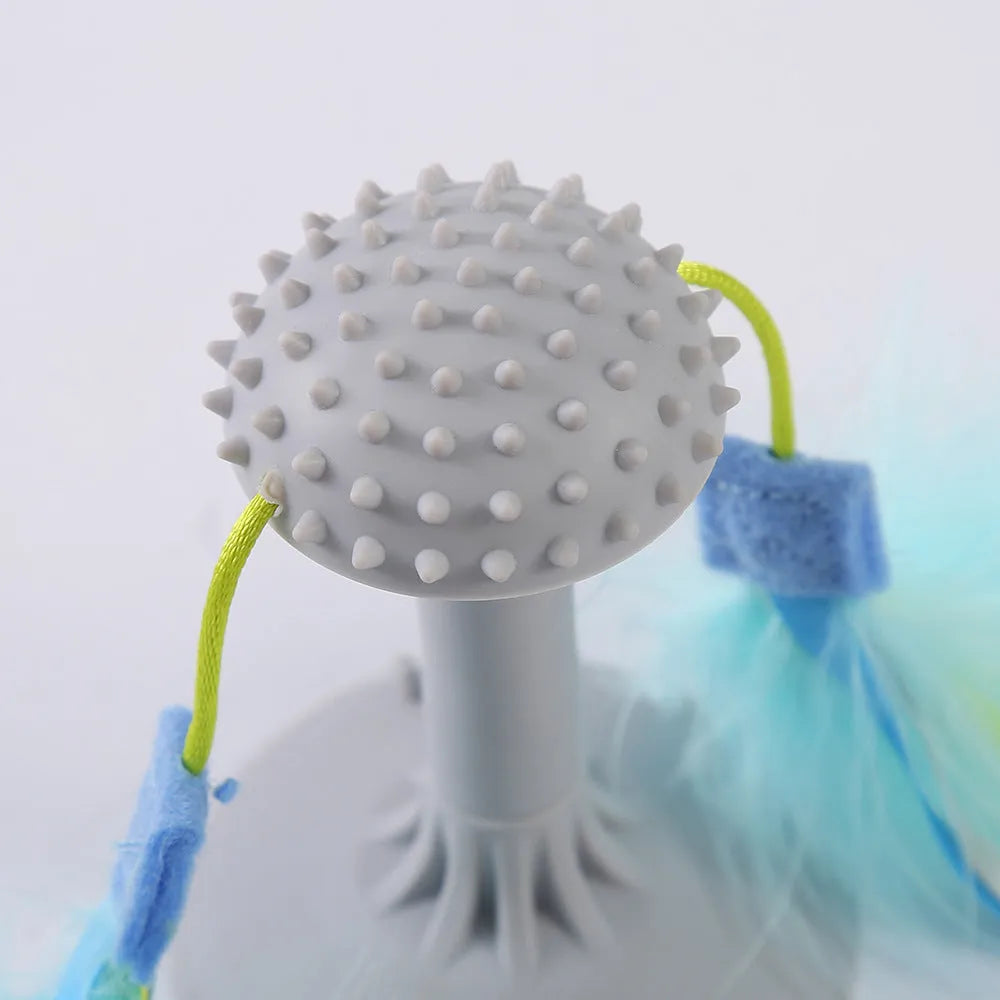 Blue cat toy wand with suction cup, double haired prick head, and plastic grinding teeth element.