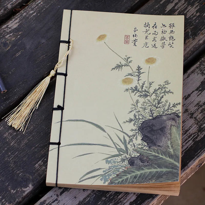 A5 antique wire-bound notebook with glossy embossed cover featuring a retro painting design, shown open.