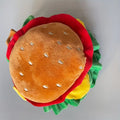 Cat wearing burger headdress collar with green lettuce and red tomato details and adjustable buckle closure