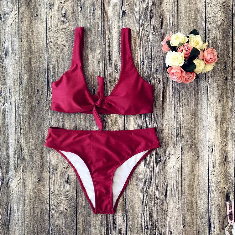 Women's solid colour bikini swimsuit set in polyester fabric, shown in black, pink, red, white, or wine red.