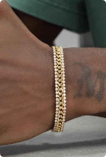 Gold plated tennis bracelet for men and women with stone inlay on a wrist.
