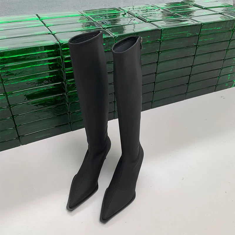 Women's black pointed-toe below-the-knee boots with a stiletto heel and a back zip fastening.
