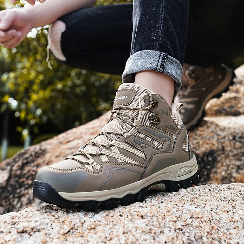 High-top hiking sneakers in multiple colours with flannel uppers and rubber soles on a rocky path.