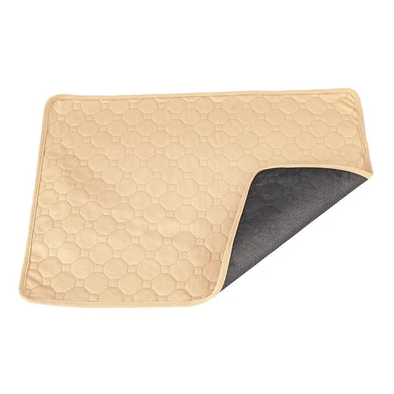 Set of two neutral-coloured washable dog pee pads on a wooden floor.