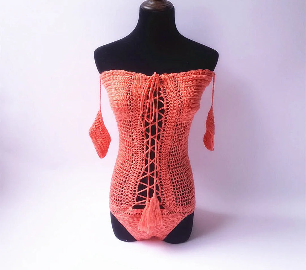 Women's off-shoulder one-piece swimsuit in light pink on a mannequin.