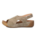 Women's beige Roman-style sandals with a fabric skirt detail, platform sole, and Velcro strap.