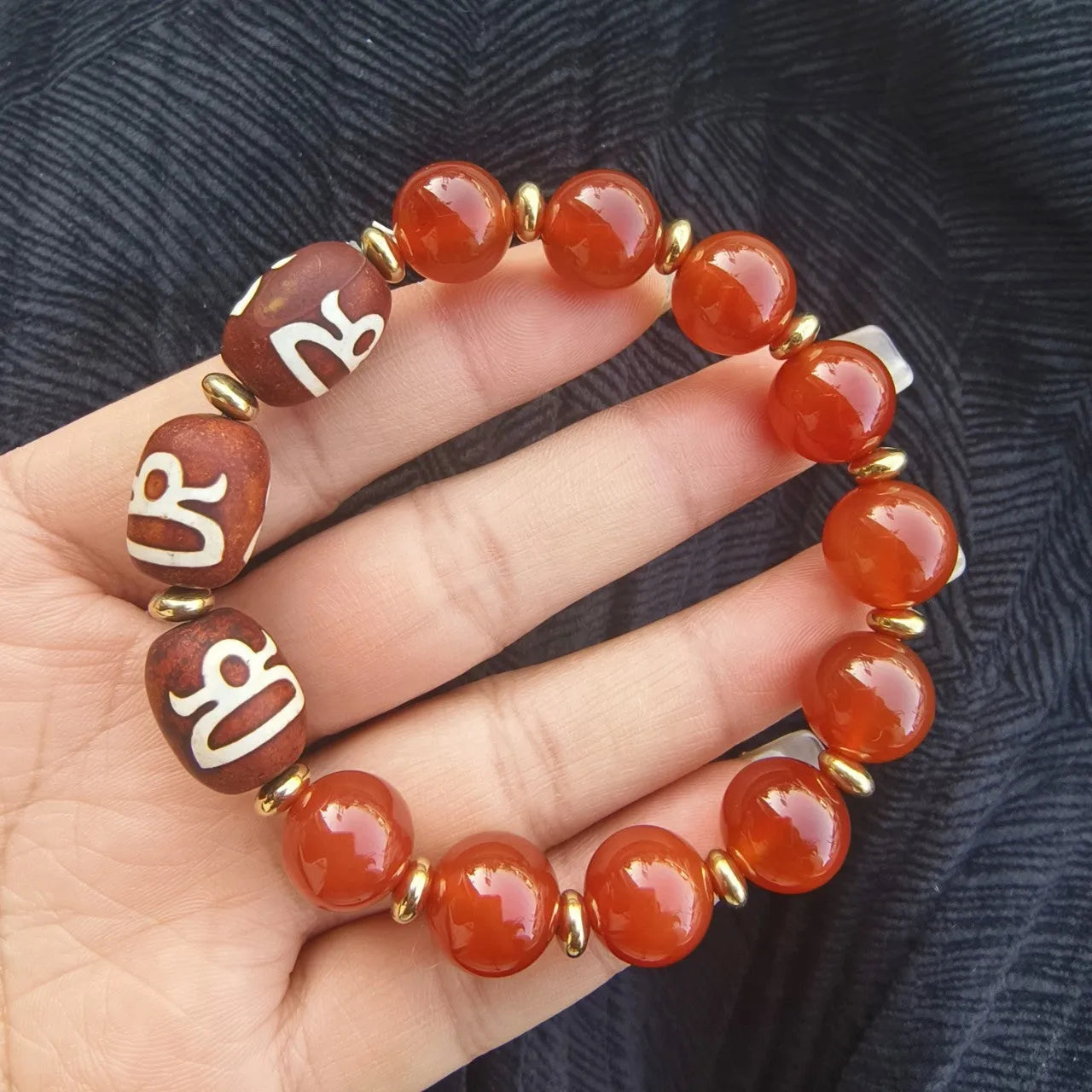 Distressed agate bracelet with traditional Tibetan dzi beads including three-eye and Nine Eyes designs.
