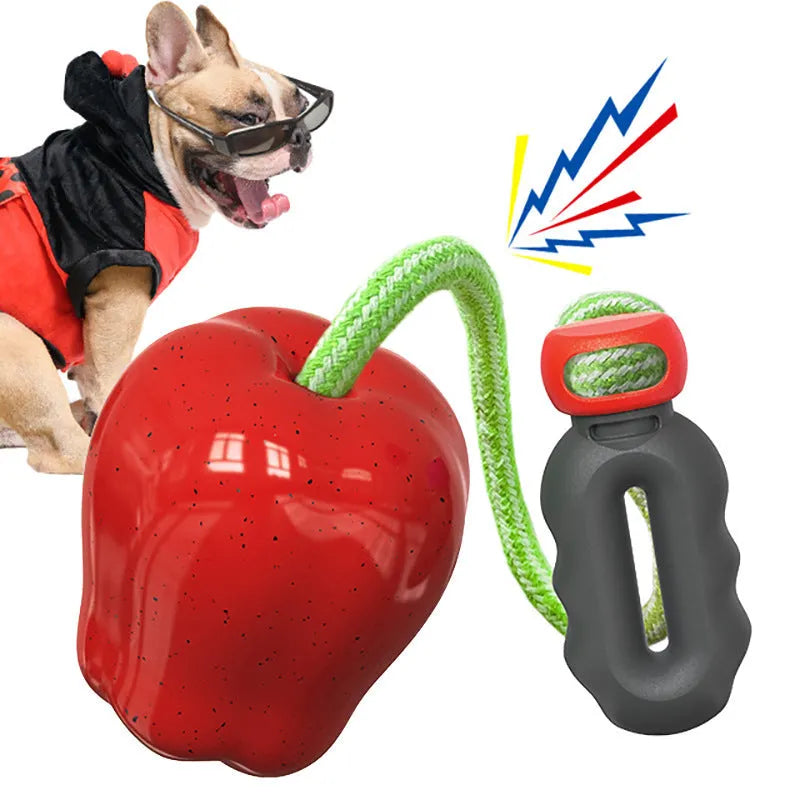 Plastic apple-shaped dog toy with squeaker in green or red for outdoor fetch and chewing
