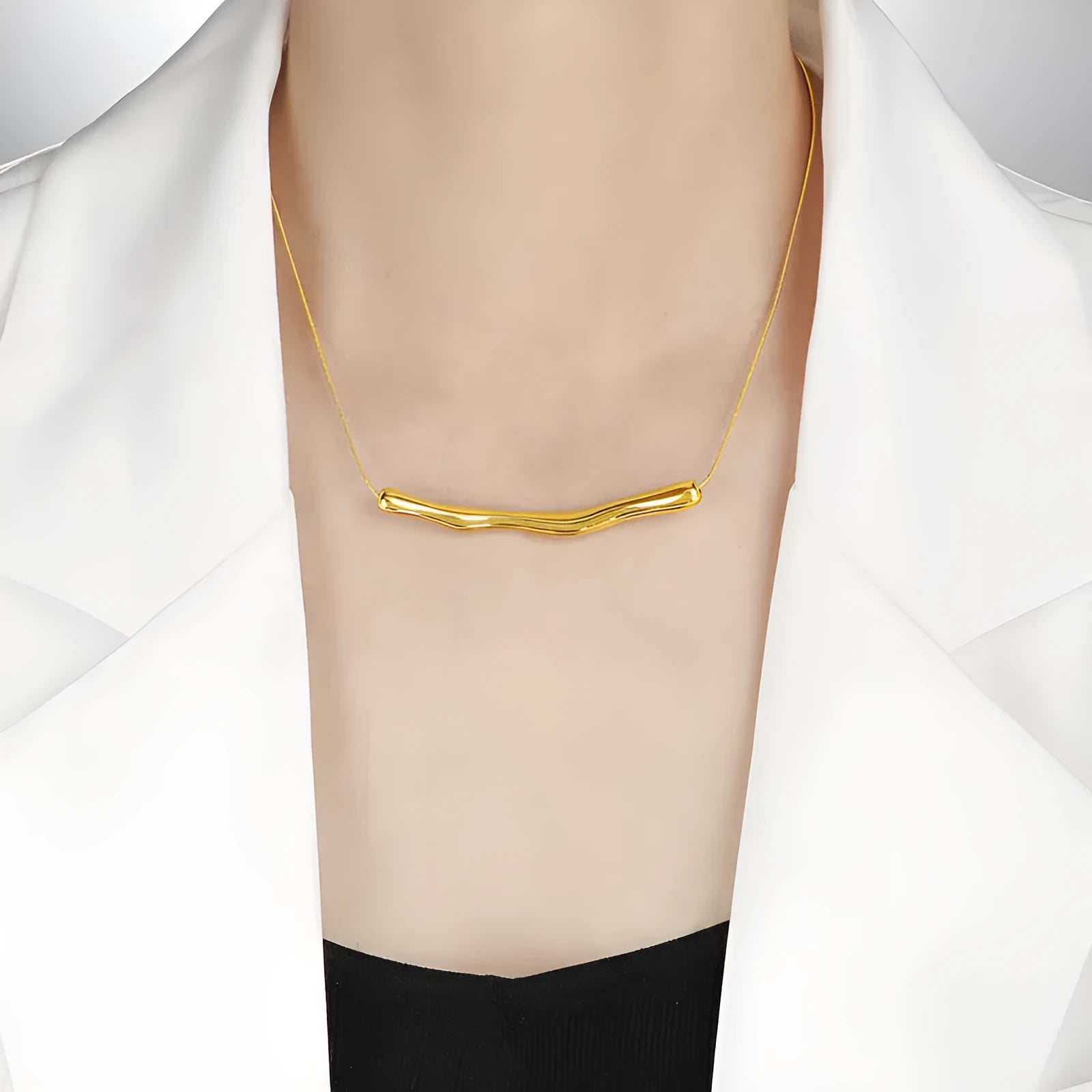 Close-up of a women's pleated titanium steel necklace in gold colour showing its textured folded design.