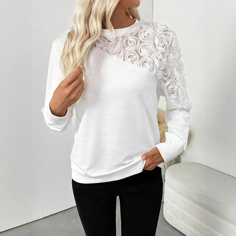 White women's long sleeve loose fit top with floral pattern.