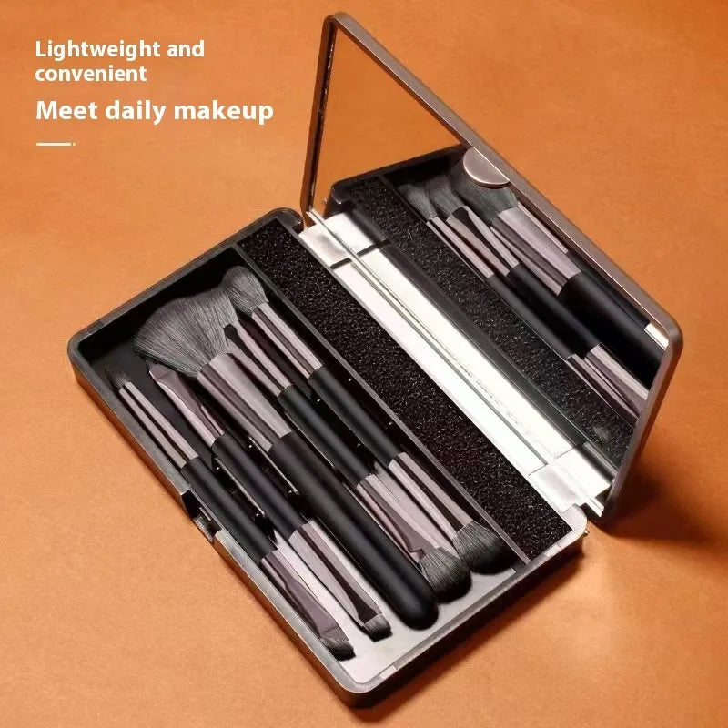 Makeup brush set with mirror case showing silver or gold handle eyeshadow brushes with artificial fibre bristles