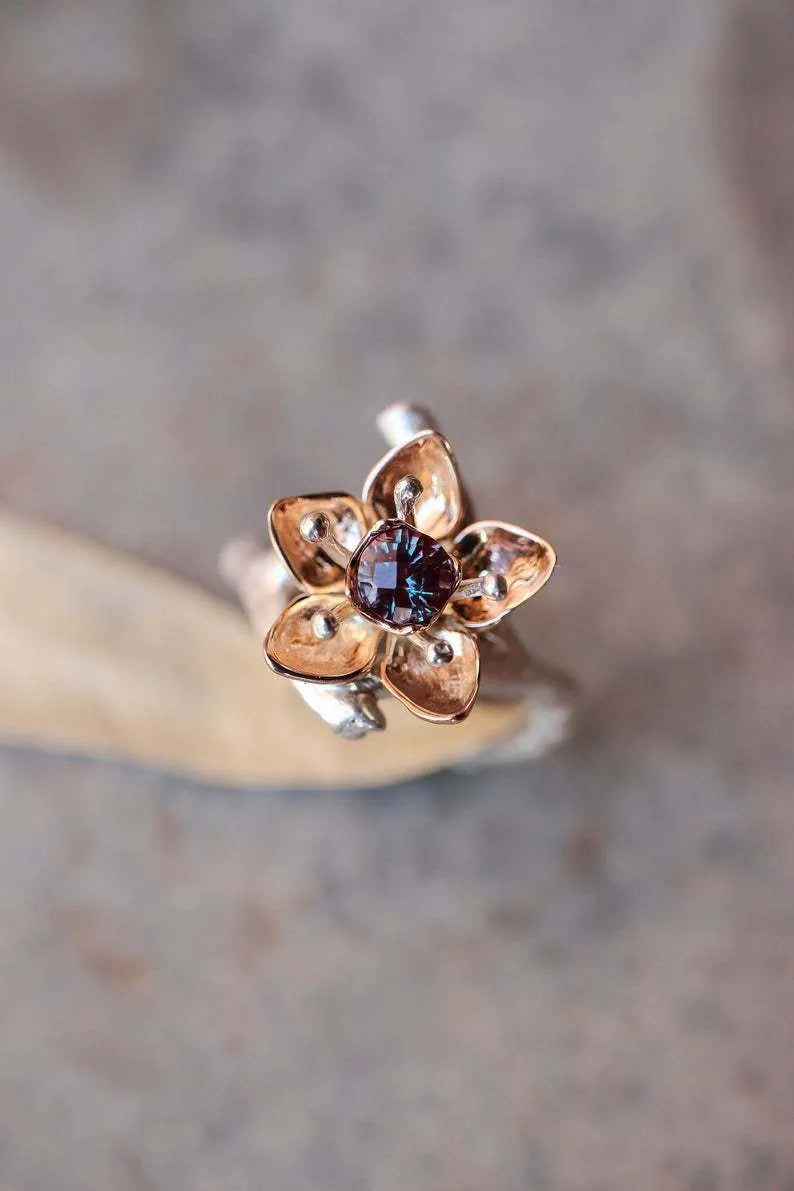Silver two-tone women's ring with geometric floral design showing alloy construction and size options