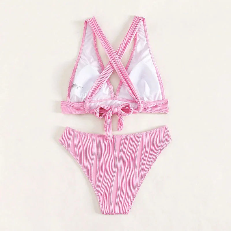 Women's black and pink halter neck bikini top with matching shorts, laid flat.
