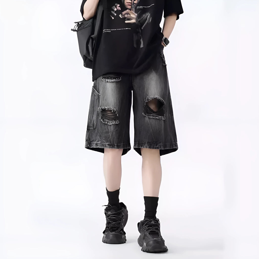 Retro loose fit denim shorts with washed and ripped detailing in blue and black colours